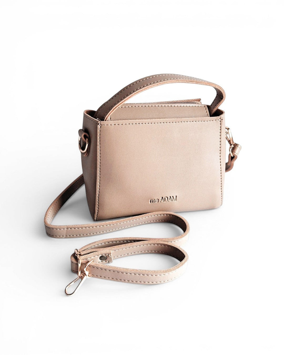 Ms. Adam beige faux leather top handle bag with detachable shoulder strap and zip closure.