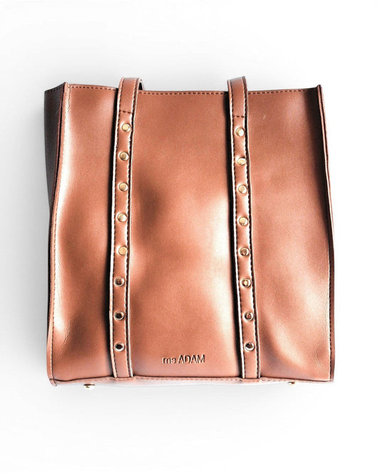 Ms. Adam brown faux leather upright tote bag with studded straps and zip closure. Features one main compartment and shoulder straps.
