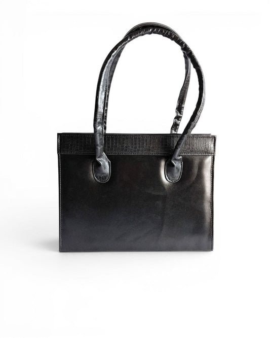 ms ADAM black faux leather top handle bag with zip closure and textured trim. Can be carried handheld or on the shoulder.