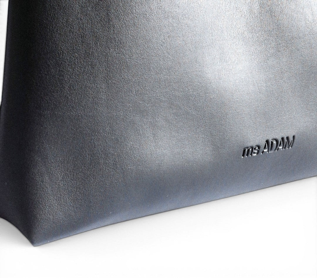ms ADAM black faux leather tote bag with zip closure and one main compartment with pocket divider.