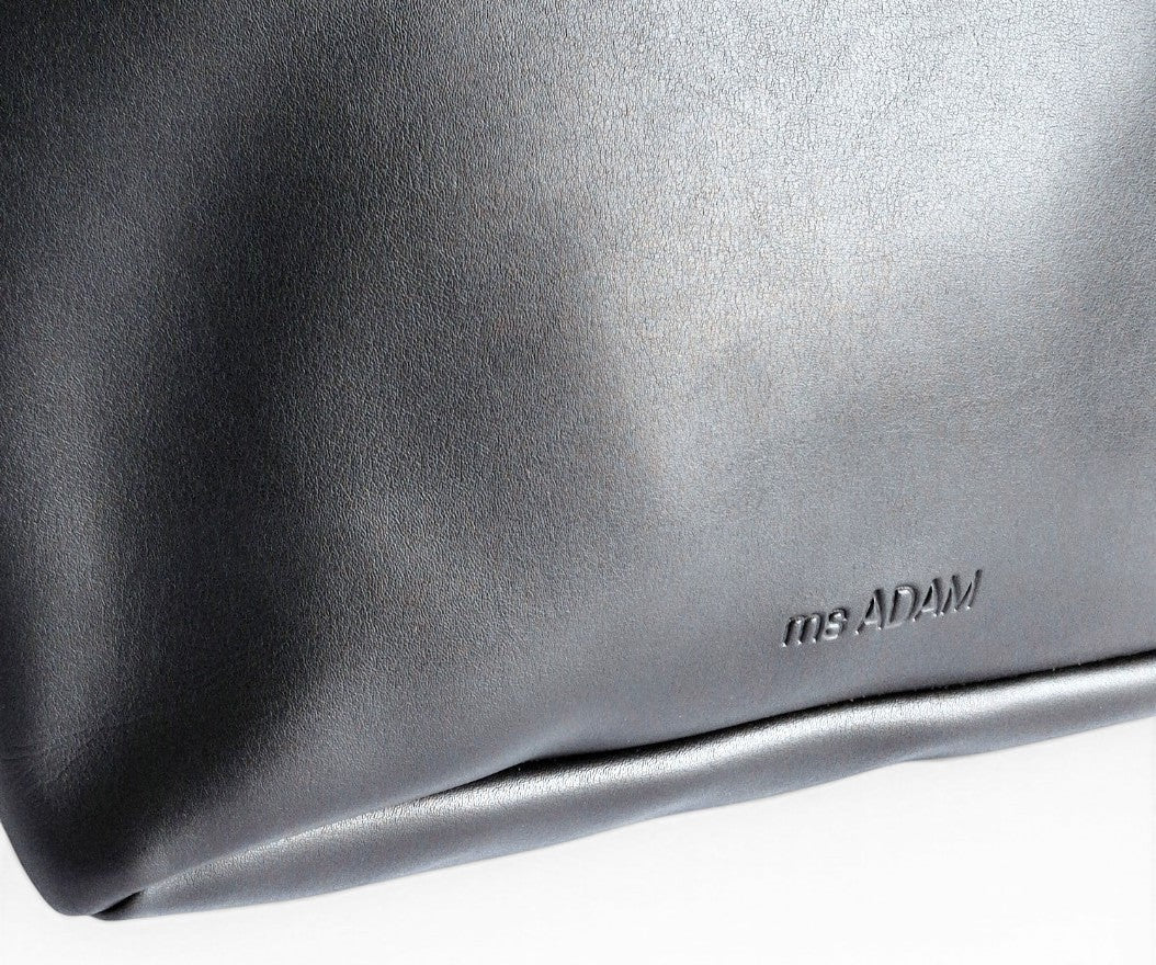 ms ADAM black faux leather tote bag with zip closure and one main compartment.