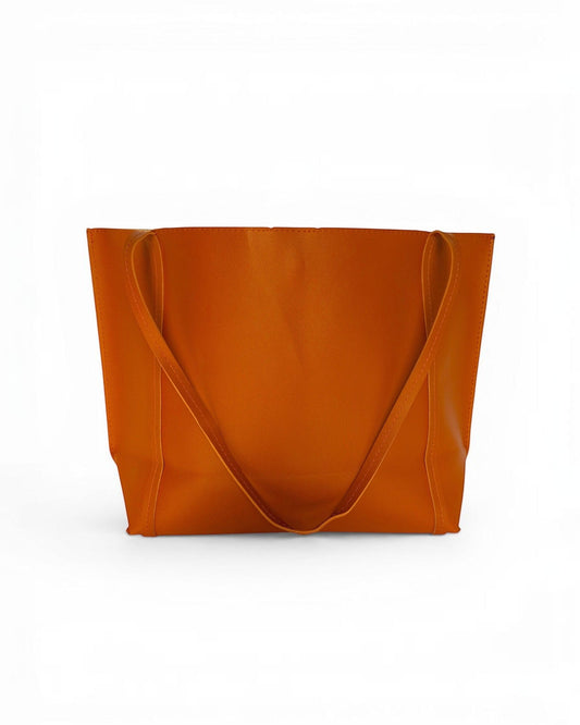 ms ADAM Go Easy Tote in rich brown faux leather. Spacious, unadorned design with shoulder straps and magnetic snap closure.