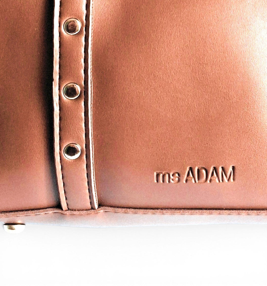 ms ADAM brown faux leather tote bag with silver stud details and zip closure. One main compartment.