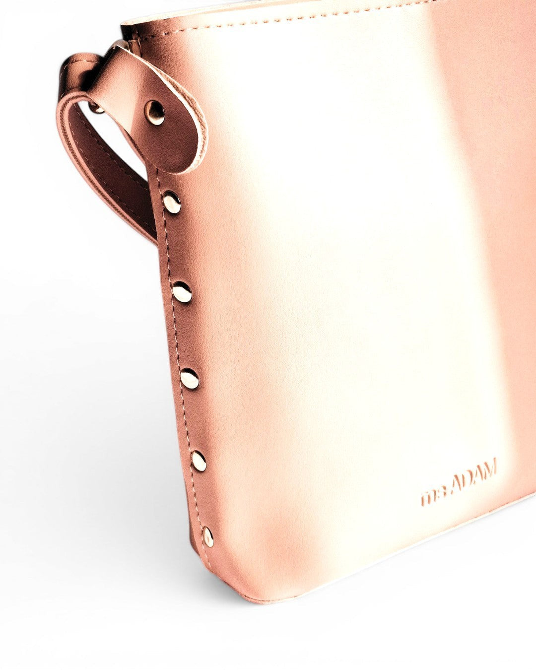 ms ADAM pink faux leather bucket bag with a fixed adjustable shoulder strap and zip closure.