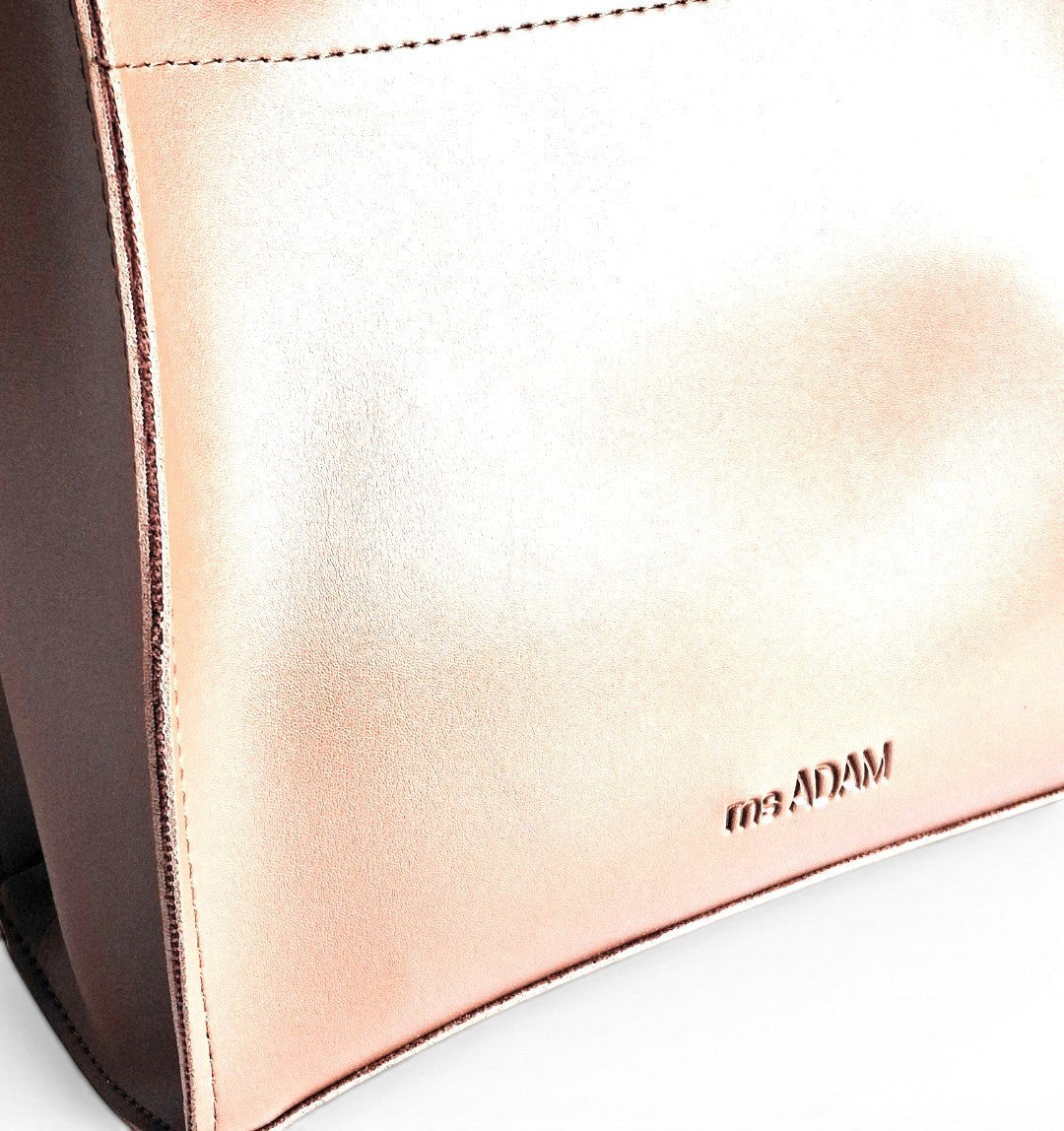 ms ADAM rose gold faux leather top handle bag with two compartments and zip closure. Detachable strap for shoulder or handheld carry.