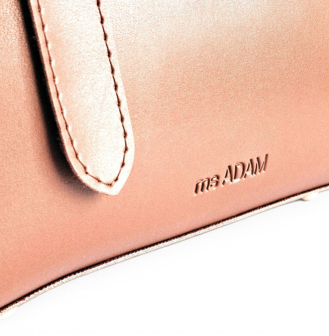 ms ADAM rose gold faux leather top handle bag with zip closure and detachable strap.