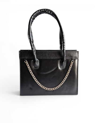 ms ADAM black faux leather top handle bag with gold chain detail and zip closure. Croc-embossed trim.