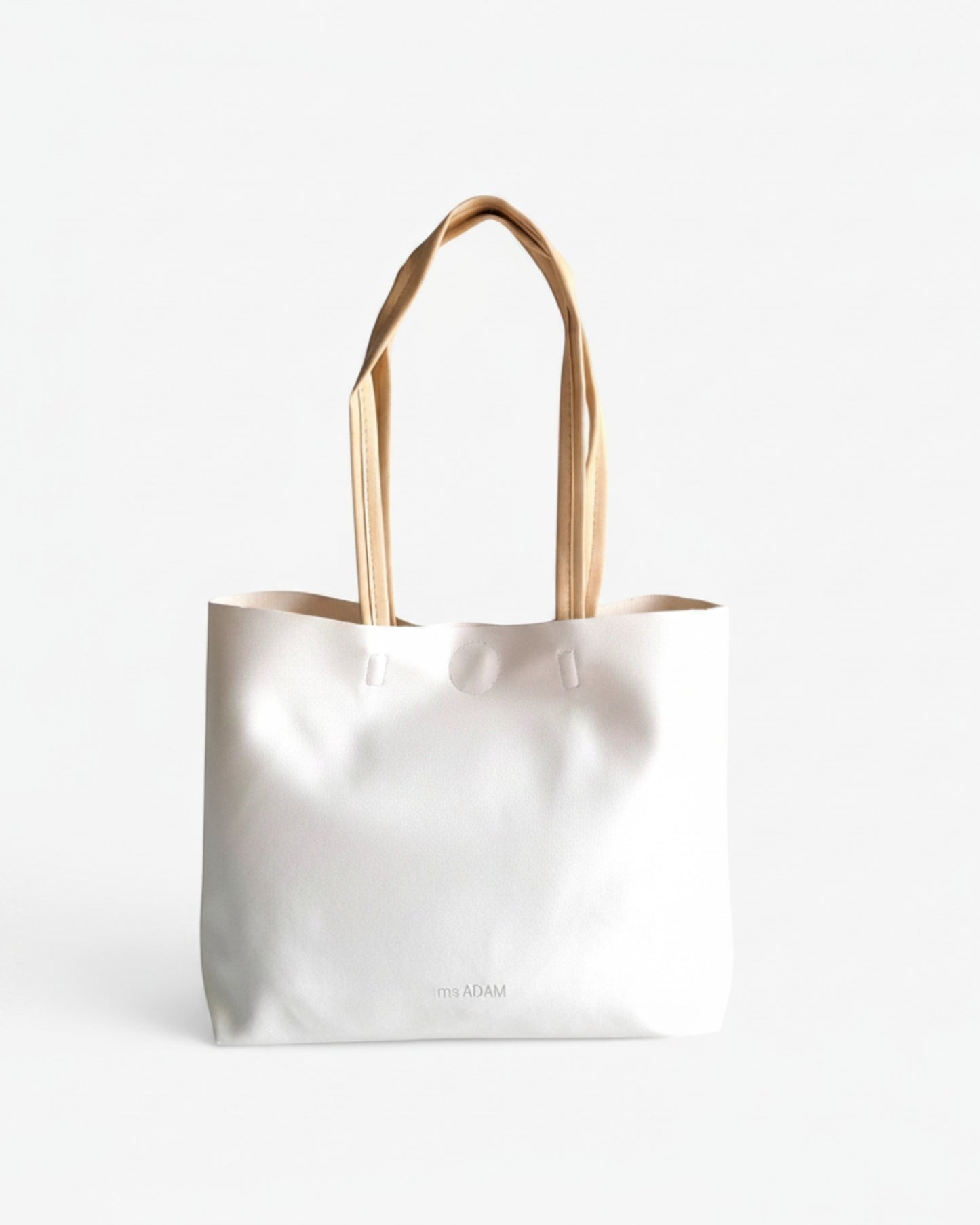 ms ADAM minimalist white faux leather tote bag with cream straps and subtle embossed logo.