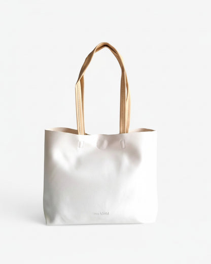 ms ADAM minimalist white faux leather tote bag with cream straps and subtle embossed logo.