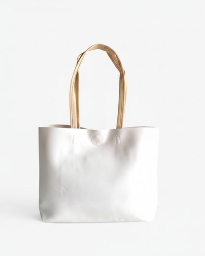 ms ADAM white faux leather minimalist tote bag with cream shoulder straps and magnetic snap closure.