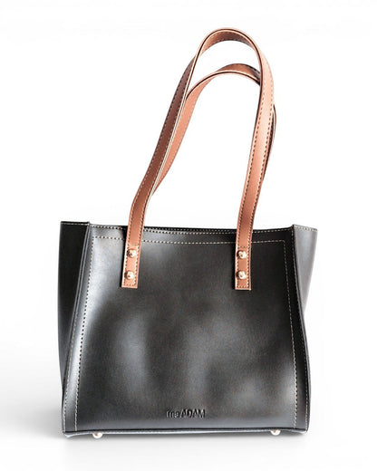 ms ADAM black faux leather tote bag with brown shoulder straps and zip closure. Unadorned texture.