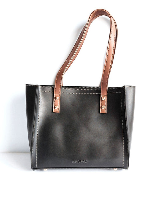 ms ADAM black faux leather tote bag with brown shoulder straps and zip closure. Unadorned texture.