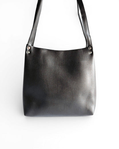 ms ADAM black faux leather bucket shoulder bag with zip closure and fixed straps.