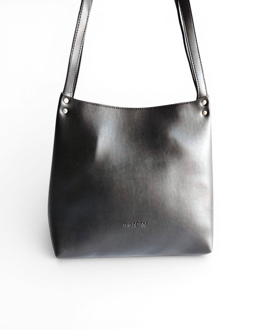 ms ADAM black faux leather bucket shoulder bag with zip closure and fixed straps.