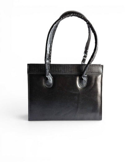 ms ADAM black faux leather top handle bag with zip closure and textured trim. Can be carried handheld or on the shoulder.