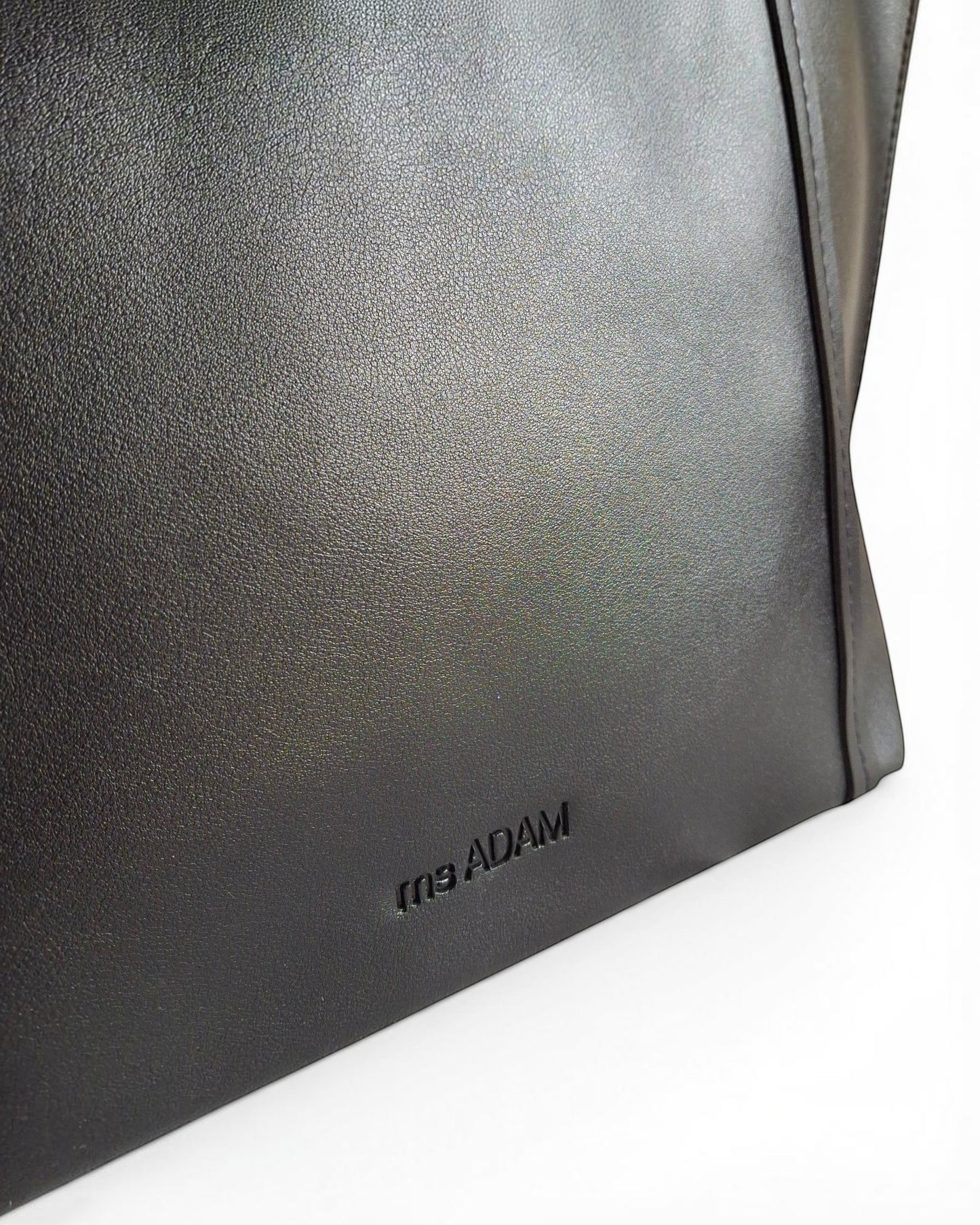 ms ADAM black faux leather tote bag with magnetic snap closure and one main compartment.