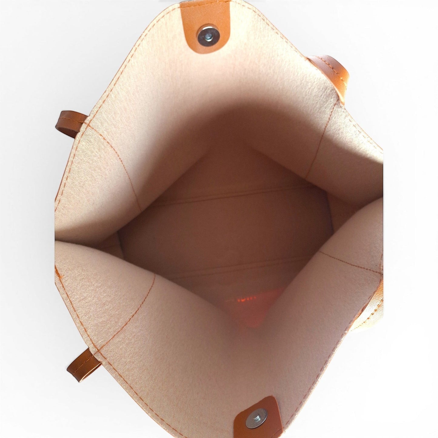 ms ADAM Go Easy Tote in brown faux leather. Spacious, unadorned tote with magnetic snap closure and one main compartment.