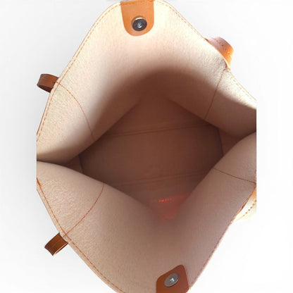 ms ADAM Go Easy Tote in brown faux leather. Spacious, unadorned tote with magnetic snap closure and one main compartment.