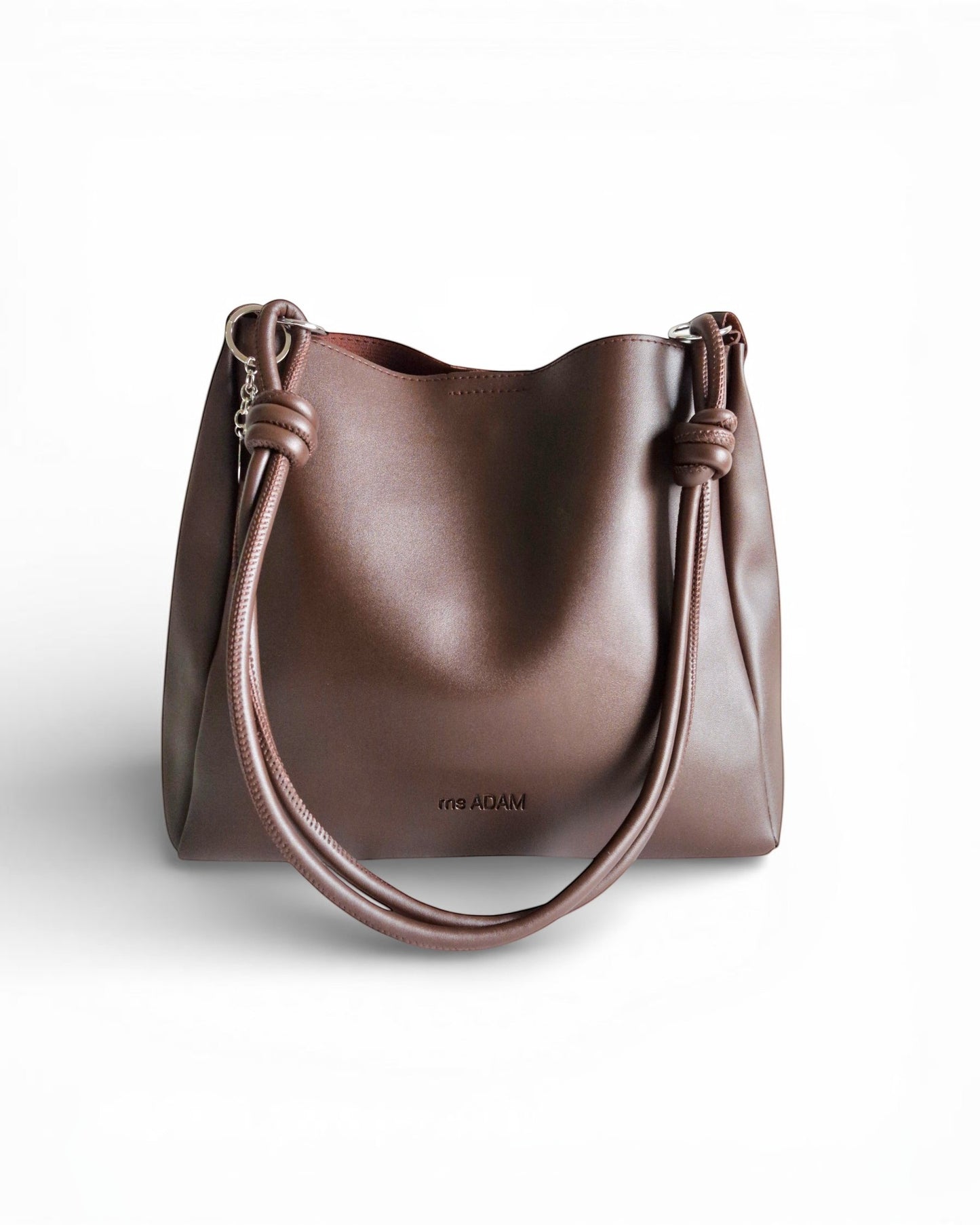 ms ADAM C Bean shoulder bag in coffee brown faux leather with knotted straps and magnetic snap closure.